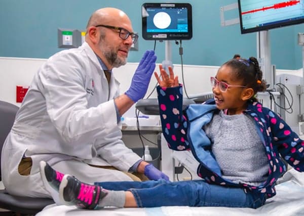 Riley doctor giving a high five to a girl Riley patient